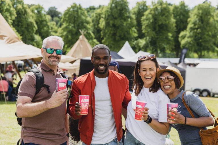 people posing with drinks 768x511
